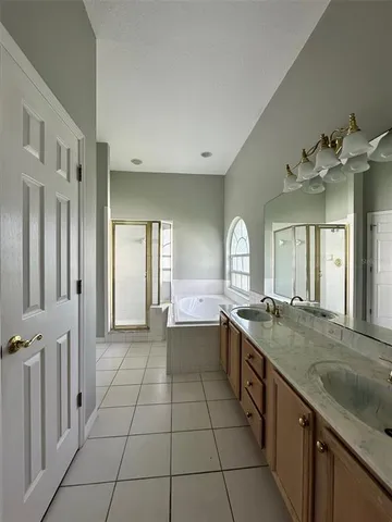 a large bathroom with a granite countertop sink a toilet a mirror and vanity