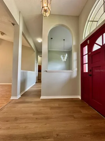 a view of a hallway with wooden floor