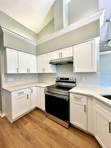 a kitchen with stainless steel appliances granite countertop a sink and cabinets