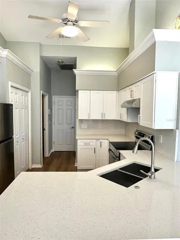 a kitchen with a stove a refrigerator and a sink