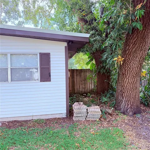 a wooden bench sitting in front of a house