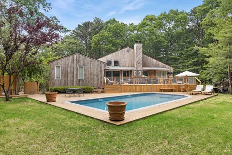 a front view of a house with swimming pool and porch