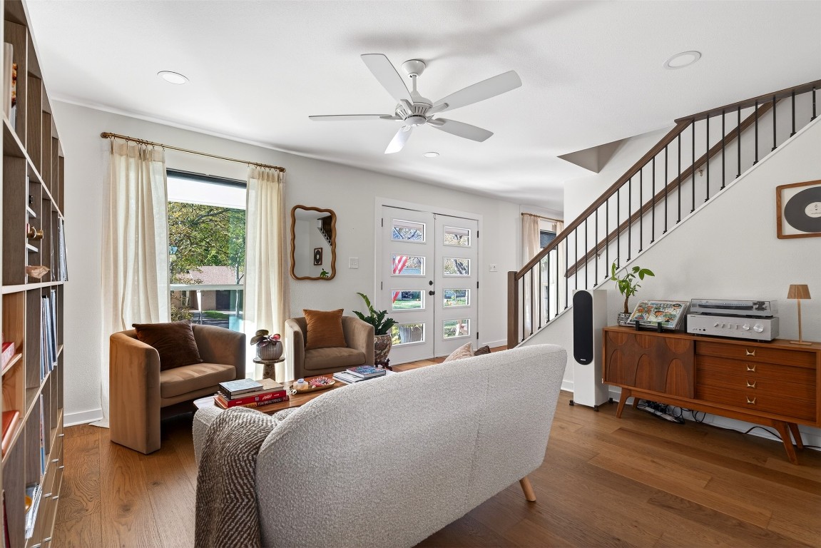 2502 Comburg Castle Way Austin, TX 78748 - Photo 7 of 35 a living room with furniture floor to ceiling windows and a ceiling fan