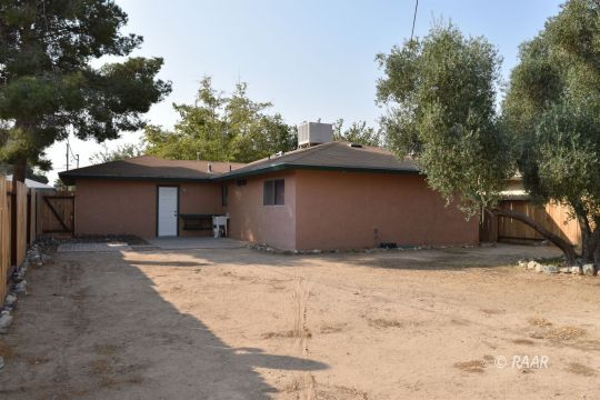 1116 West St George Avenue Ridgecrest, CA 93555 - Photo 17 of 17 a house with a tree in the background