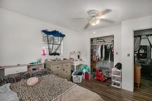 a bedroom with a bed and wooden floor