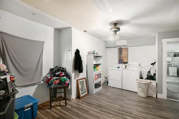 a view of a workspace with furniture and a flat screen tv