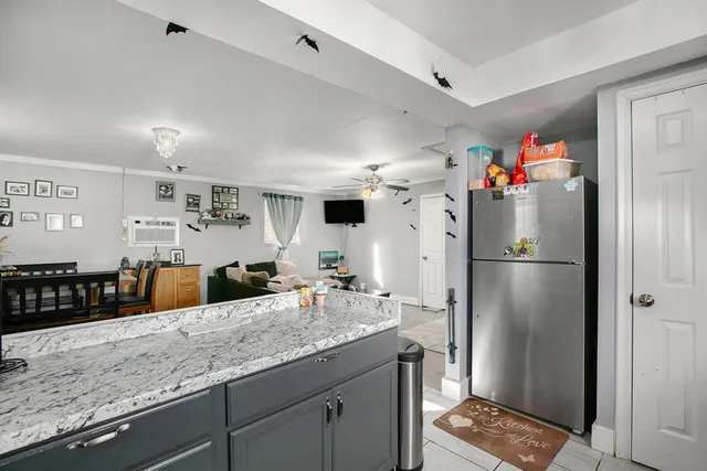 a kitchen with stainless steel appliances granite countertop a refrigerator and a sink