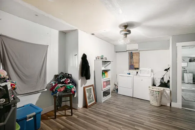 a view of a workspace with furniture and a flat screen tv