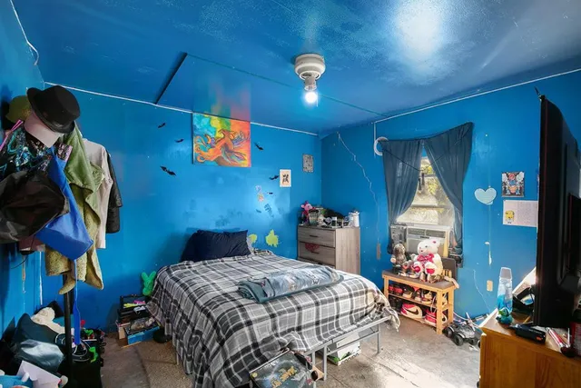 a bedroom with bed and a chandelier