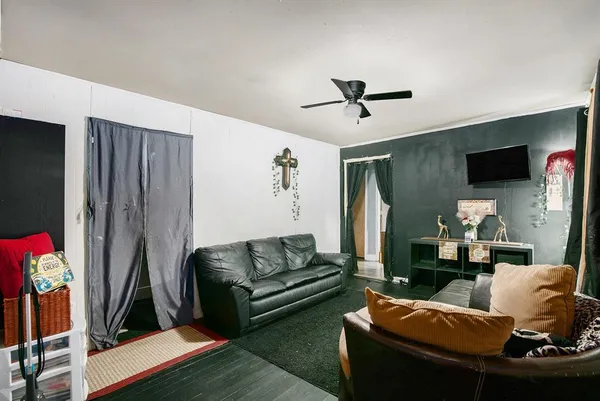 a living room with furniture a flat screen tv and a table