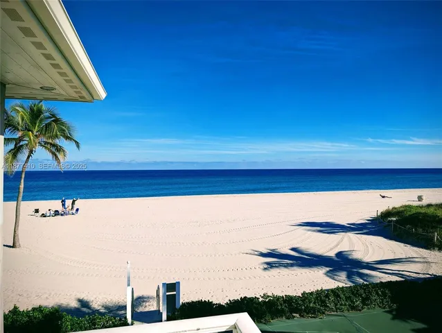 a view of swimming pool with lawn chairs