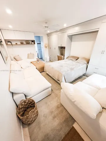 a bedroom with a bed and a painting on the wall