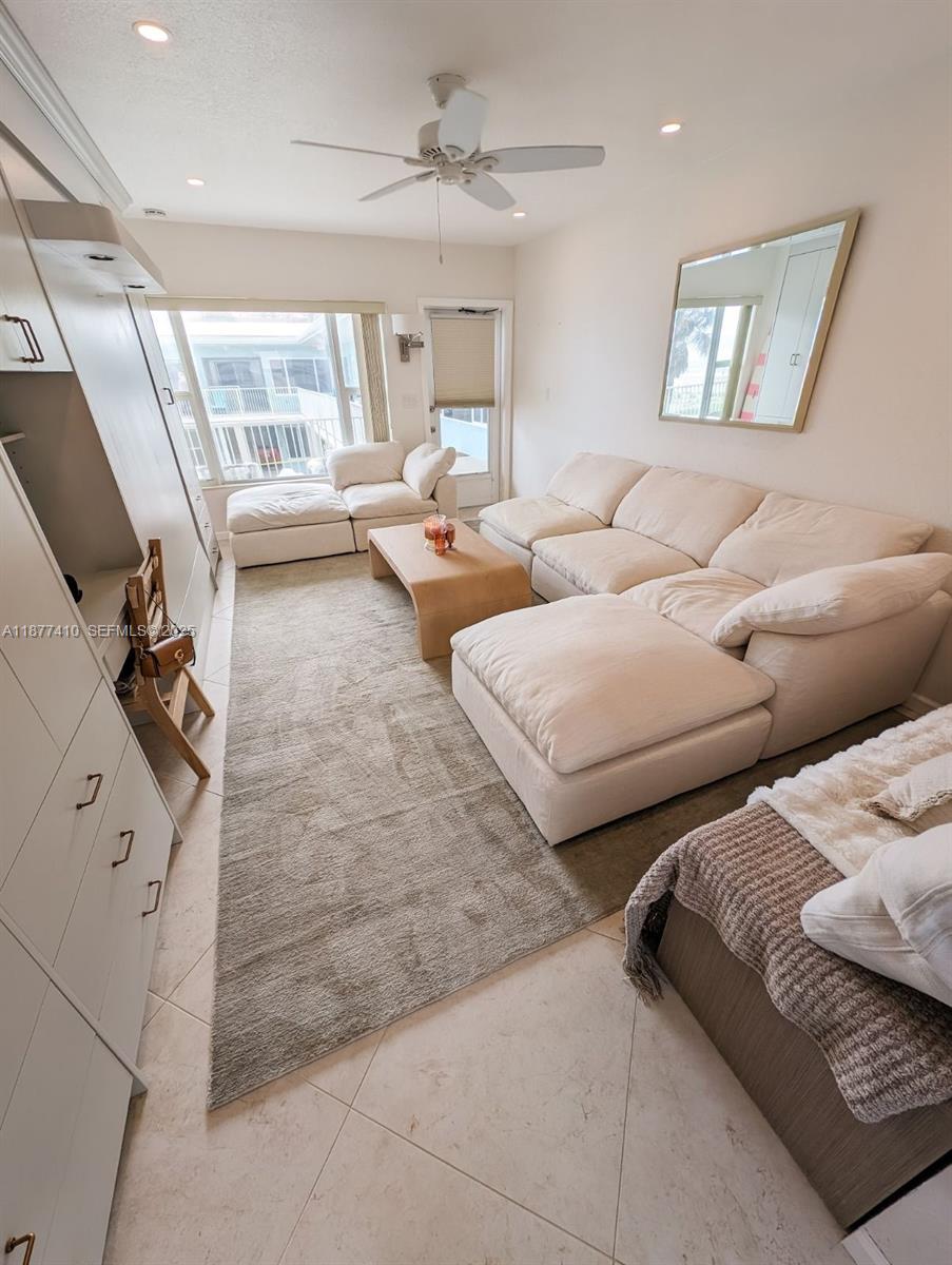 1501 South Surf Road, Unit 21 Hollywood, FL 33019 - Photo 5 of 9 a living room with furniture and a large window