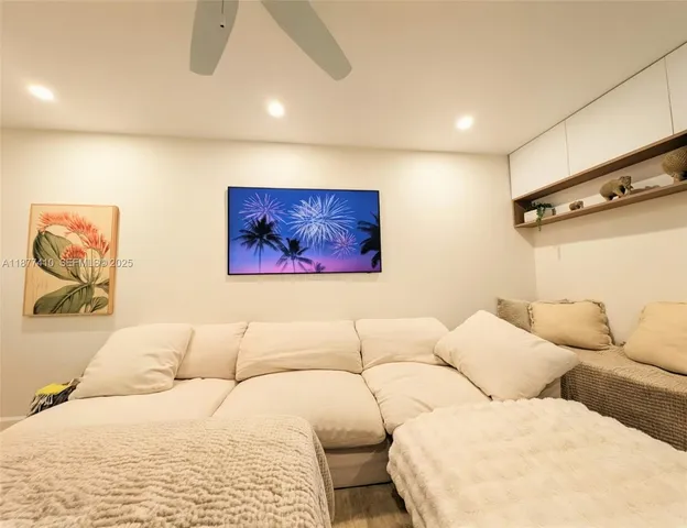 a living room with couches and painting on the wall