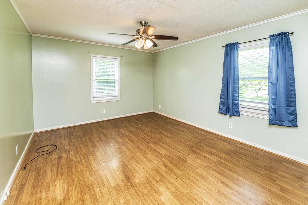 725 Old Brownsville Road Ripley, TN 38063 - Photo 13 of 40 a view of empty room with wooden floor and fan