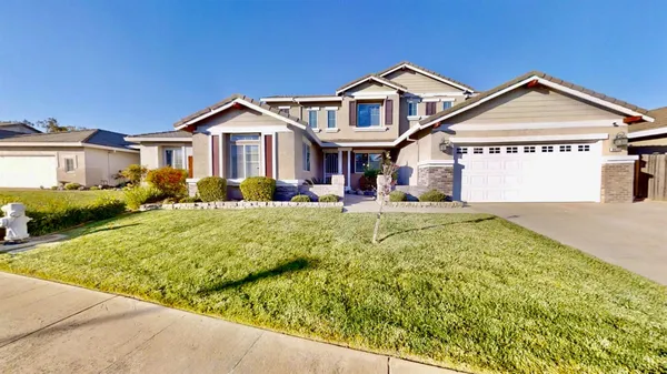a front view of a house with a yard