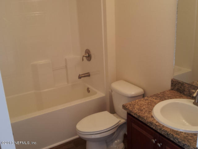 2527 Spring Pond Lane Jacksonville, FL 32221 - Photo 7 of 13 a bathroom with a granite countertop toilet a sink and bathtub