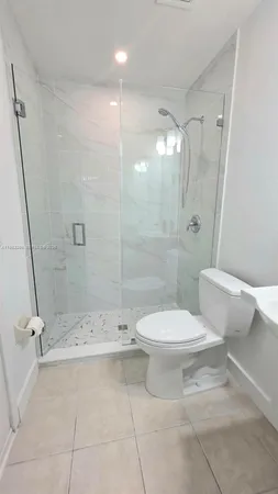 a spacious bathroom with a shower and a sink