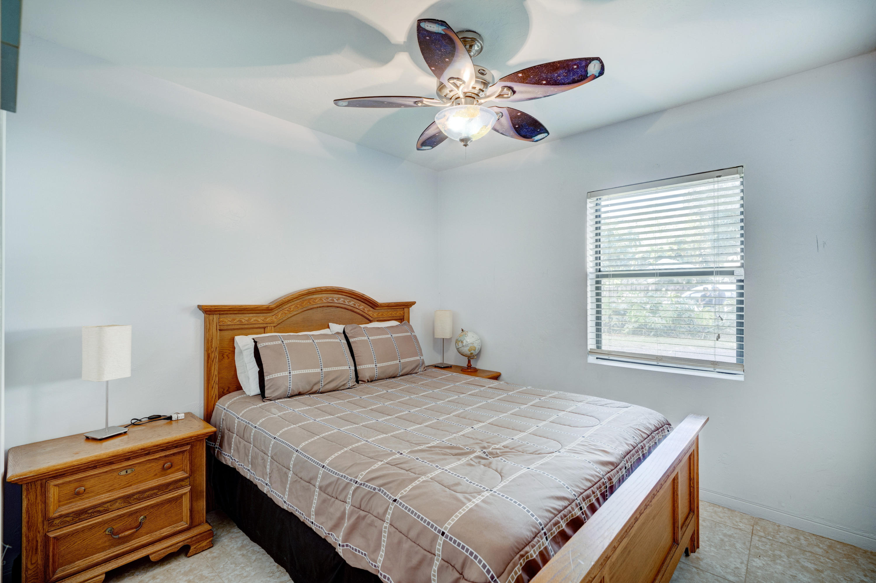 11061 Ellison Wilson Road North Palm Beach, FL 33408 - Photo 11 of 41 a bedroom with a bed and a chandelier