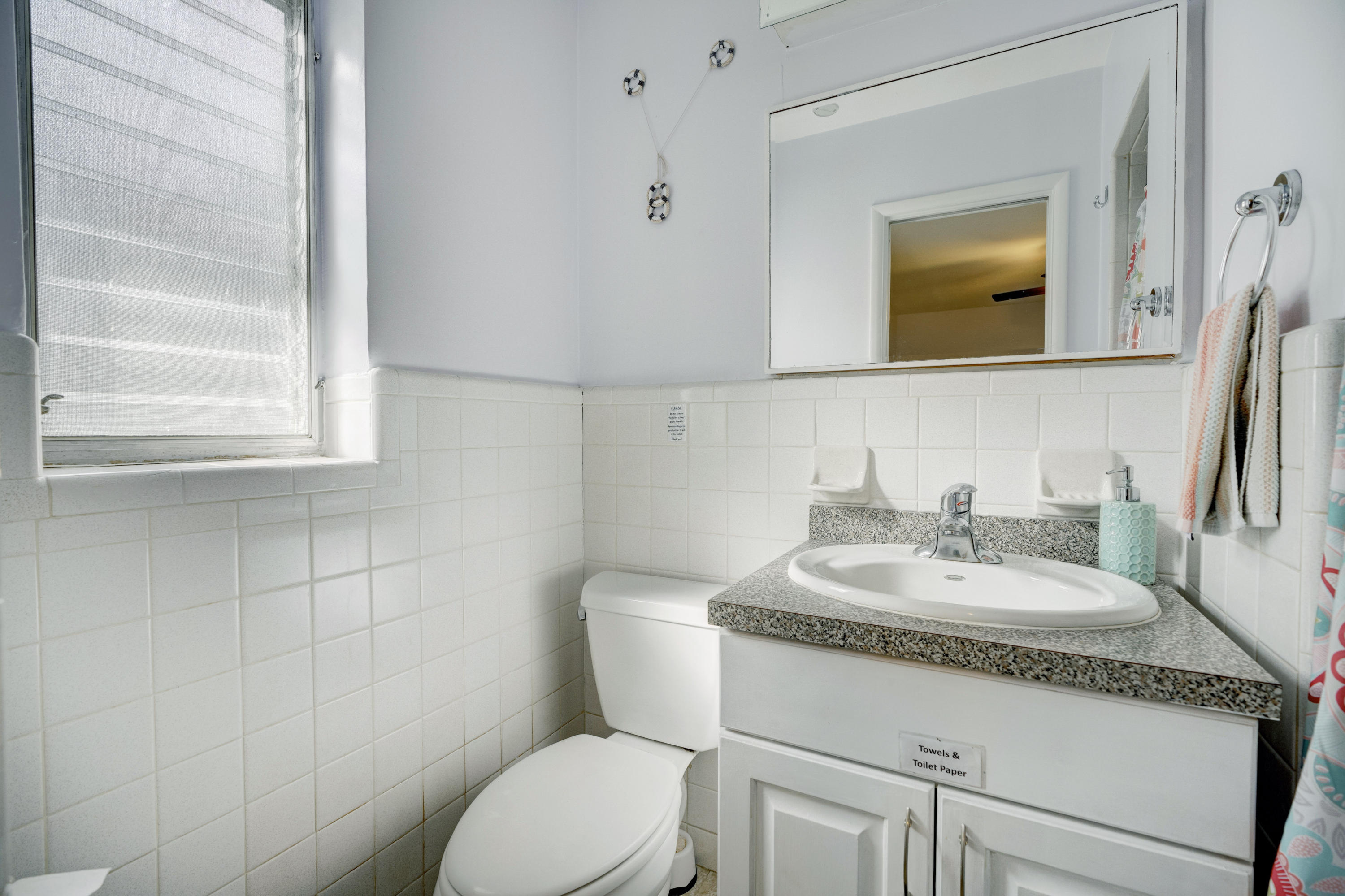 11061 Ellison Wilson Road North Palm Beach, FL 33408 - Photo 13 of 41 a bathroom with a granite countertop toilet sink and mirror