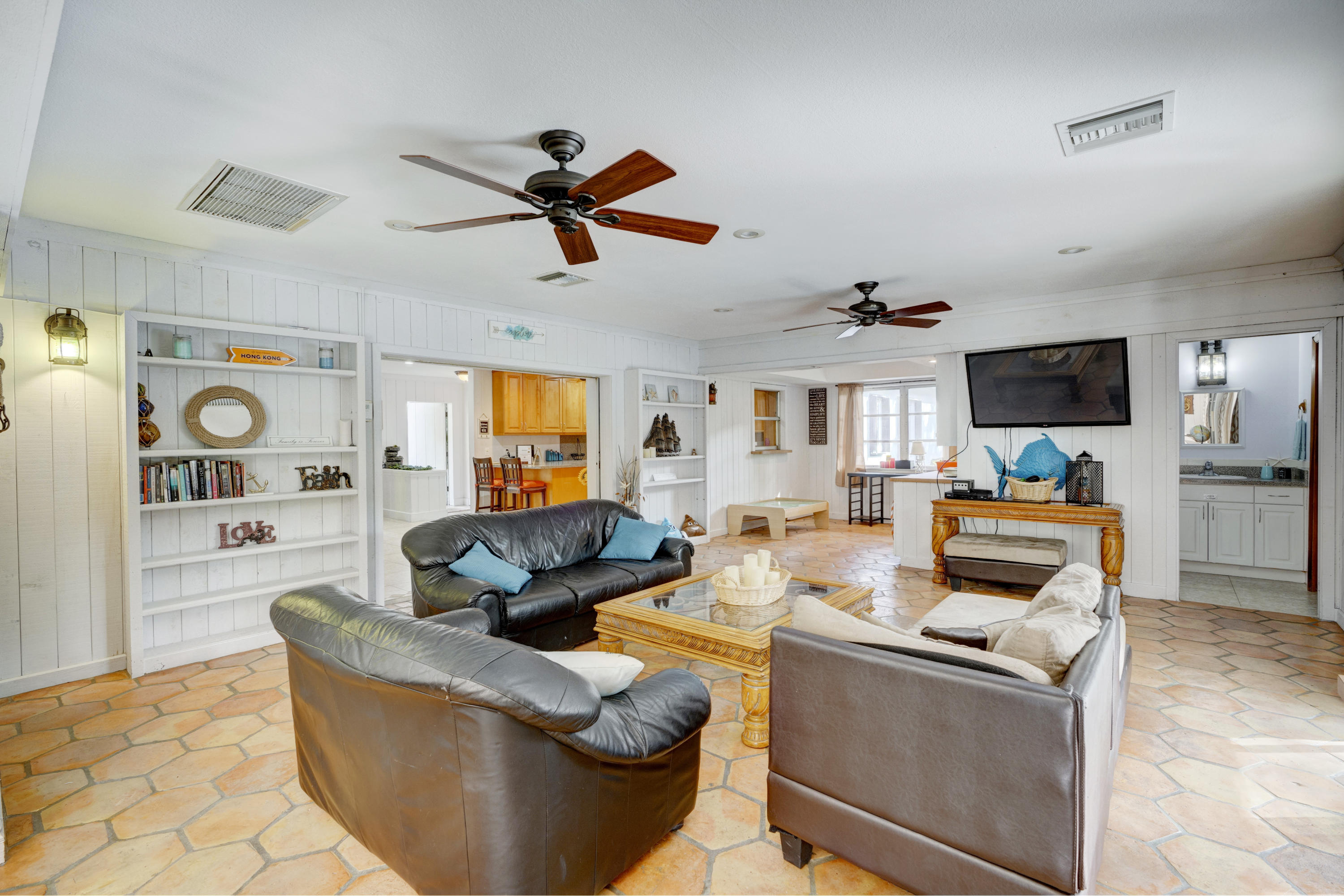 11061 Ellison Wilson Road North Palm Beach, FL 33408 - Photo 17 of 41 a living room with furniture and a flat screen tv