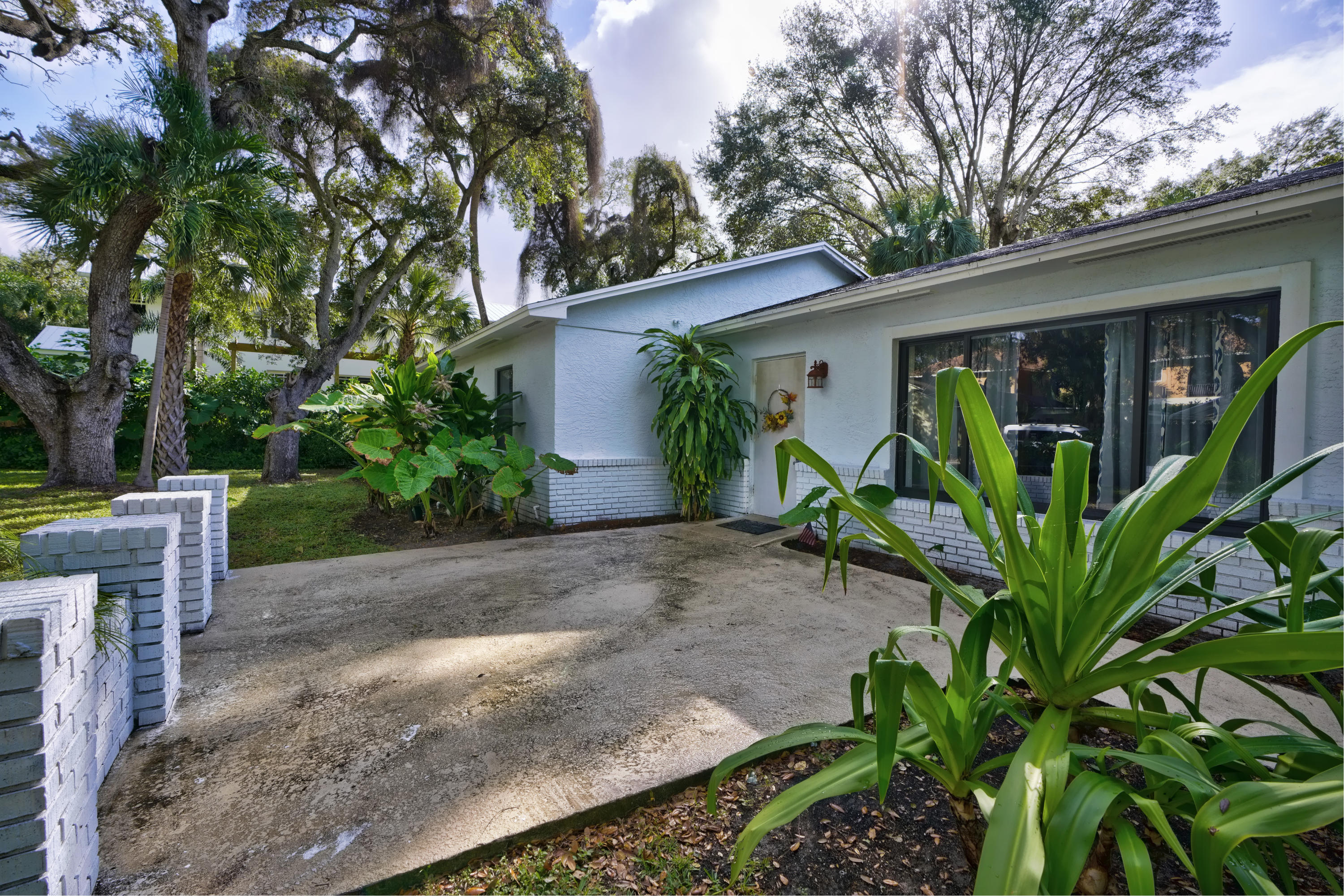 11061 Ellison Wilson Road North Palm Beach, FL 33408 - Photo 2 of 41 a front view of a house with garden