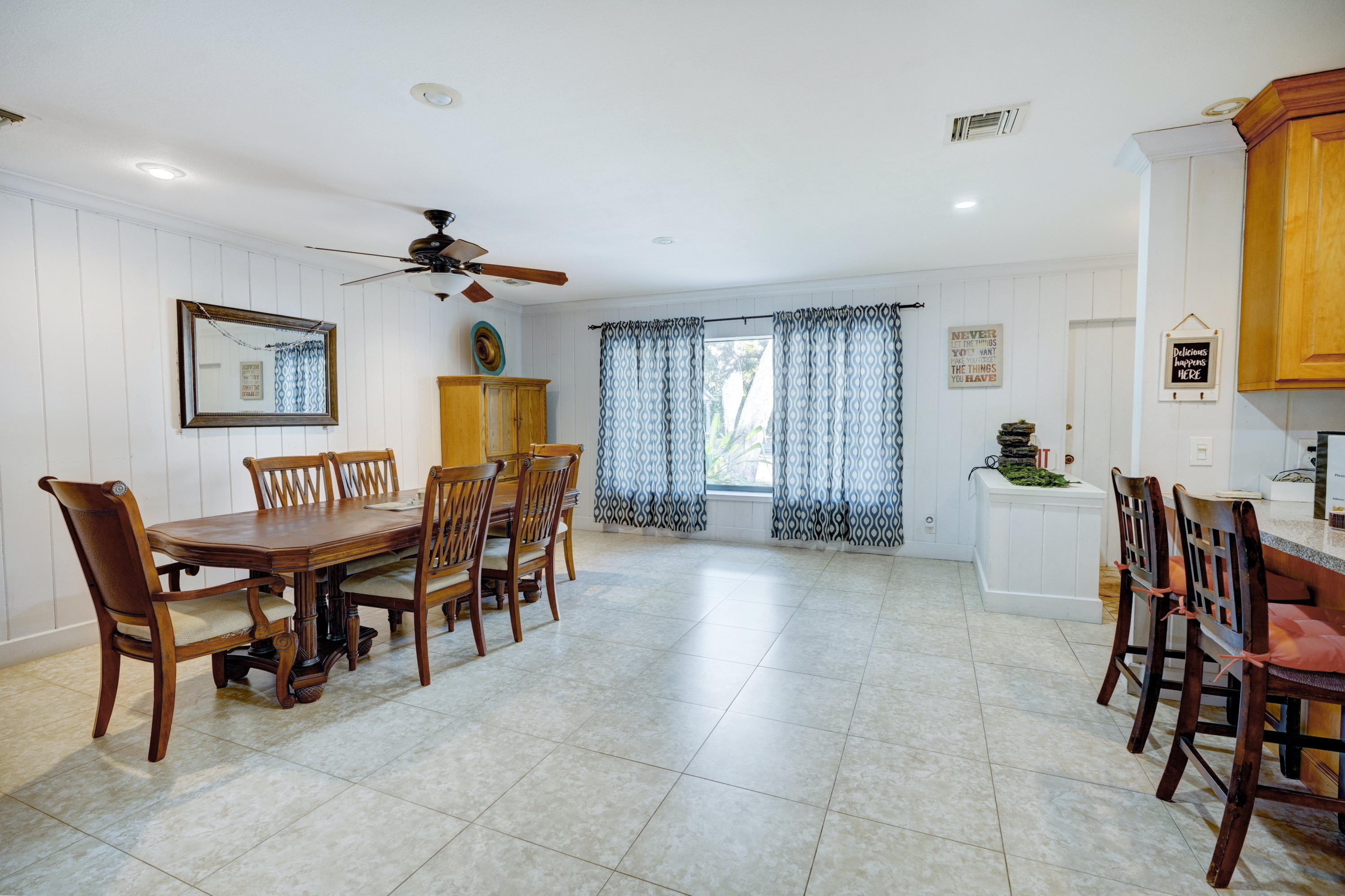 11061 Ellison Wilson Road North Palm Beach, FL 33408 - Photo 22 of 41 a view of a dining room with furniture and chandelier