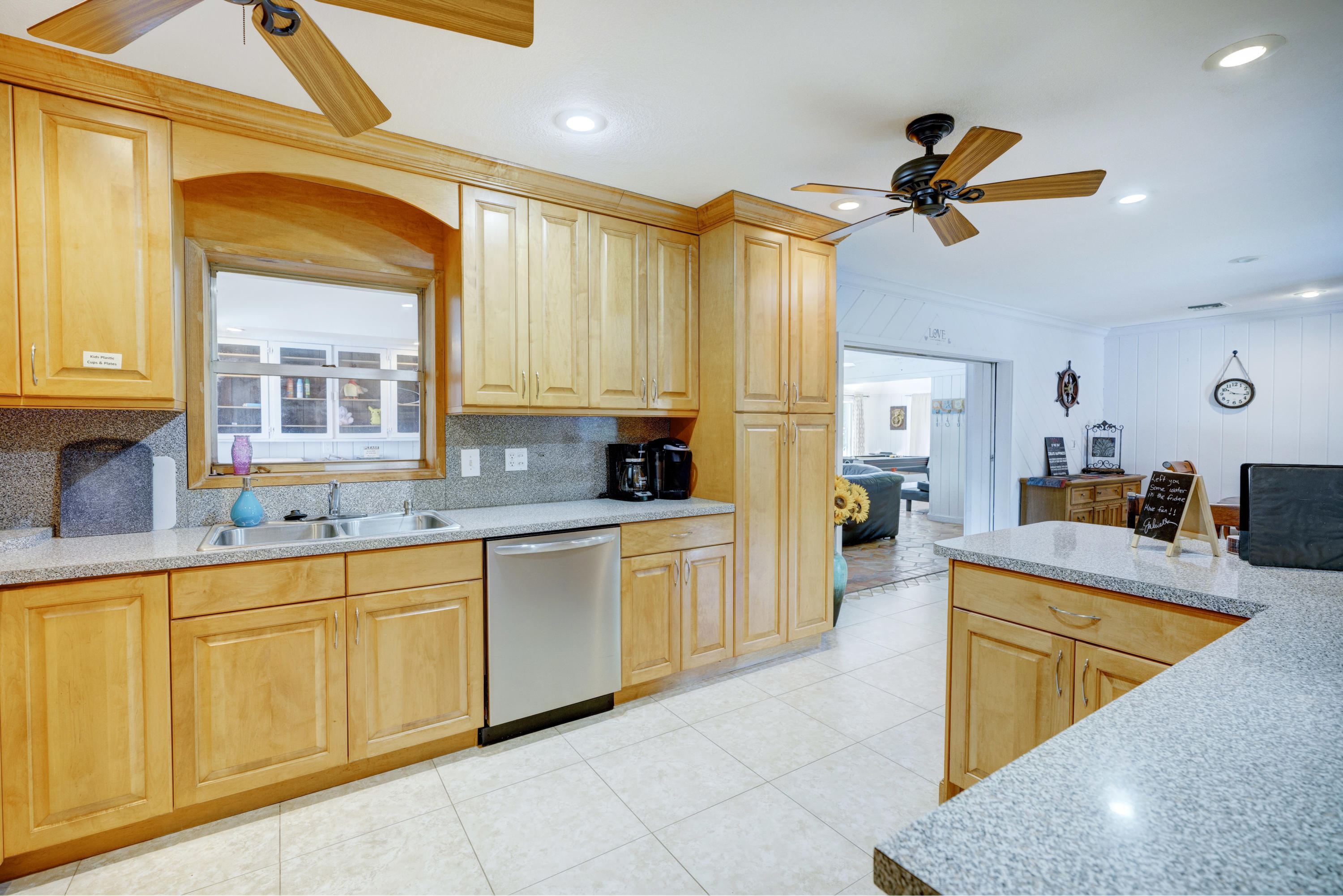 11061 Ellison Wilson Road North Palm Beach, FL 33408 - Photo 25 of 41 a large kitchen with kitchen island a large counter top space a sink a window and stainless steel appliances
