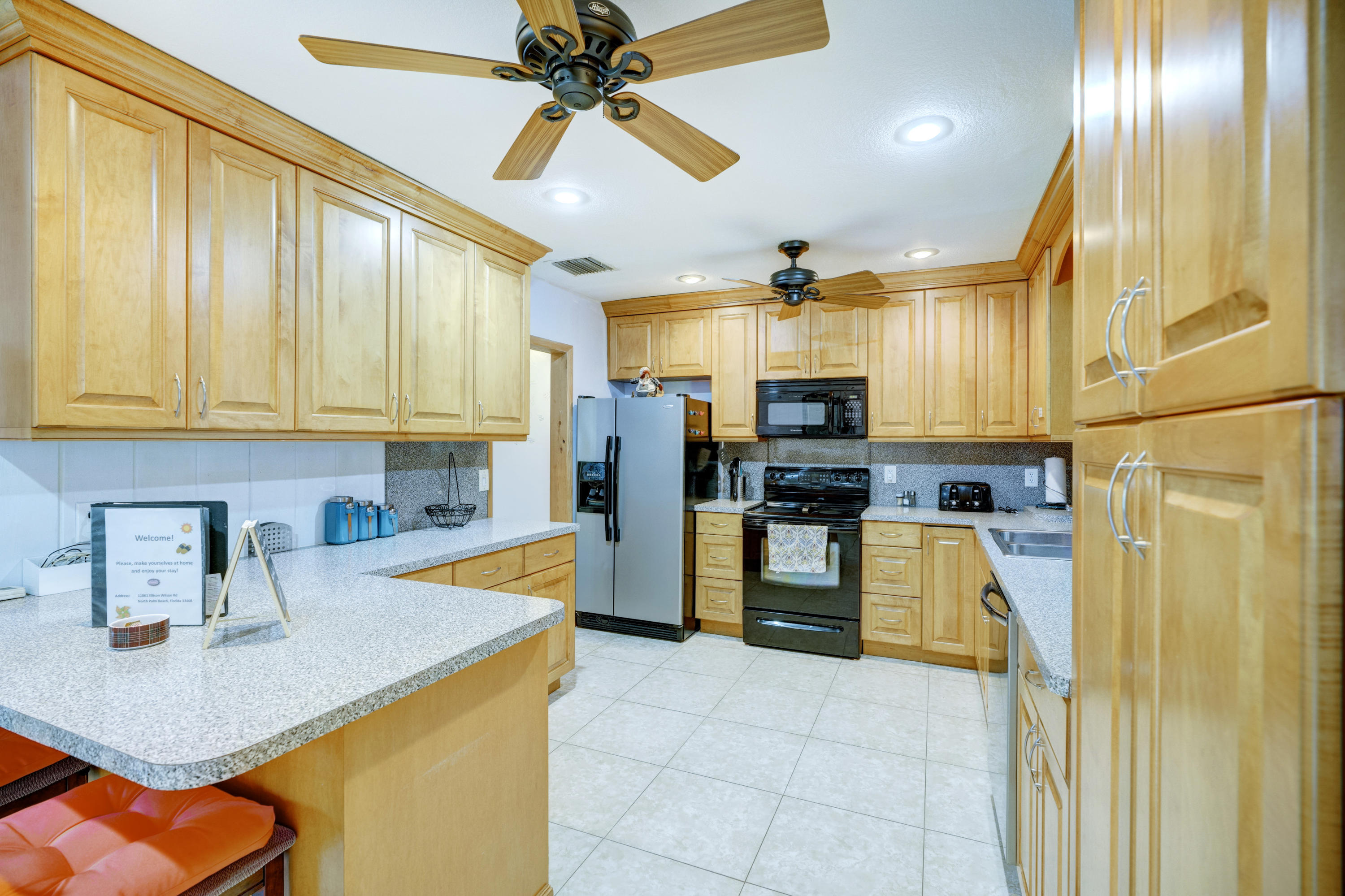 11061 Ellison Wilson Road North Palm Beach, FL 33408 - Photo 27 of 41 a kitchen with a refrigerator and a sink