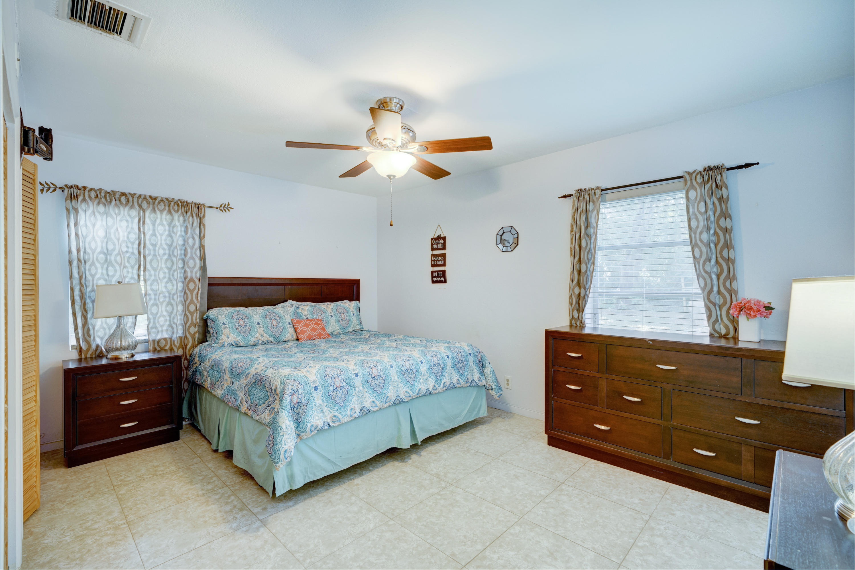 11061 Ellison Wilson Road North Palm Beach, FL 33408 - Photo 5 of 41 a bedroom with a bed and a dresser