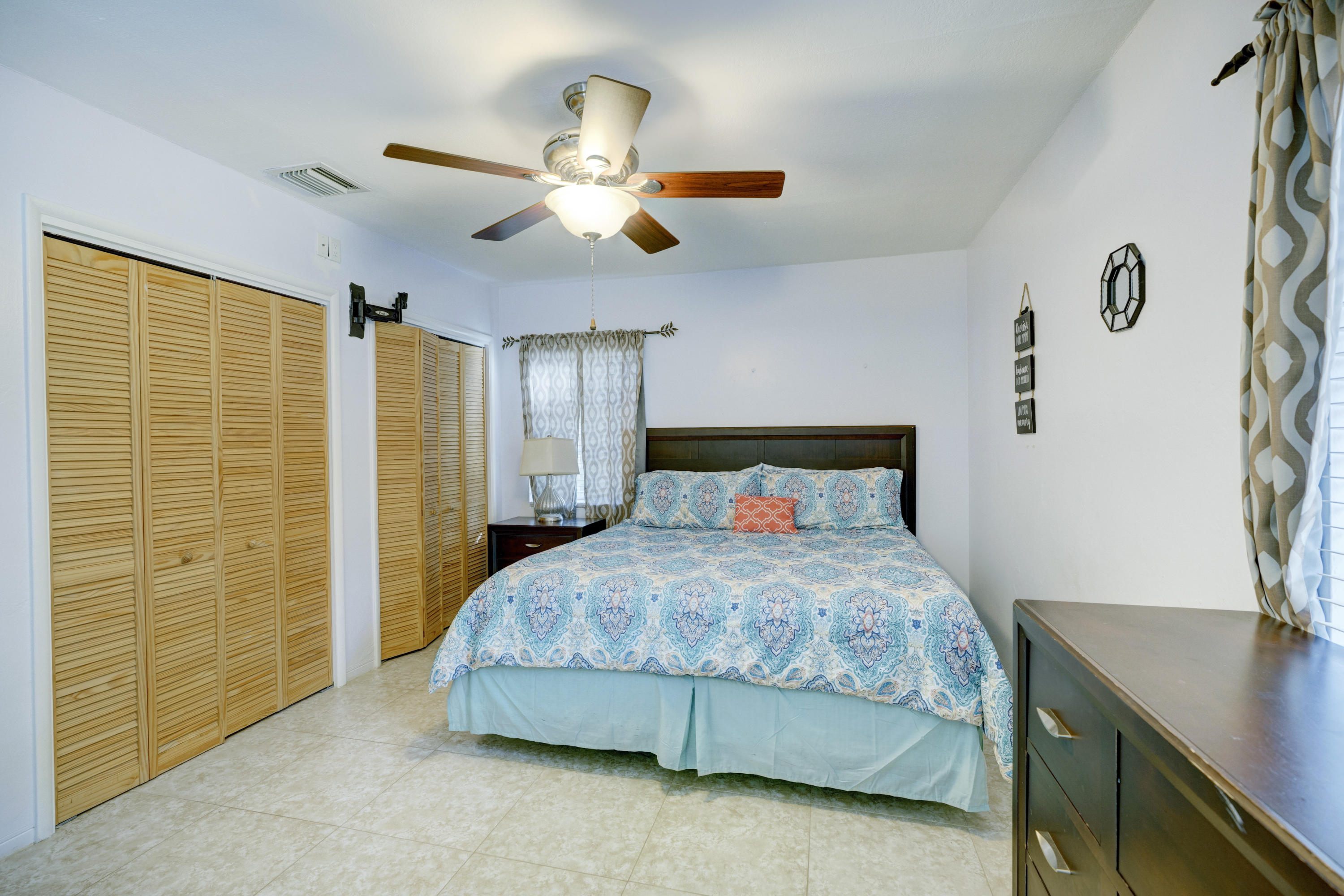 11061 Ellison Wilson Road North Palm Beach, FL 33408 - Photo 6 of 41 a bedroom with a bed and a table