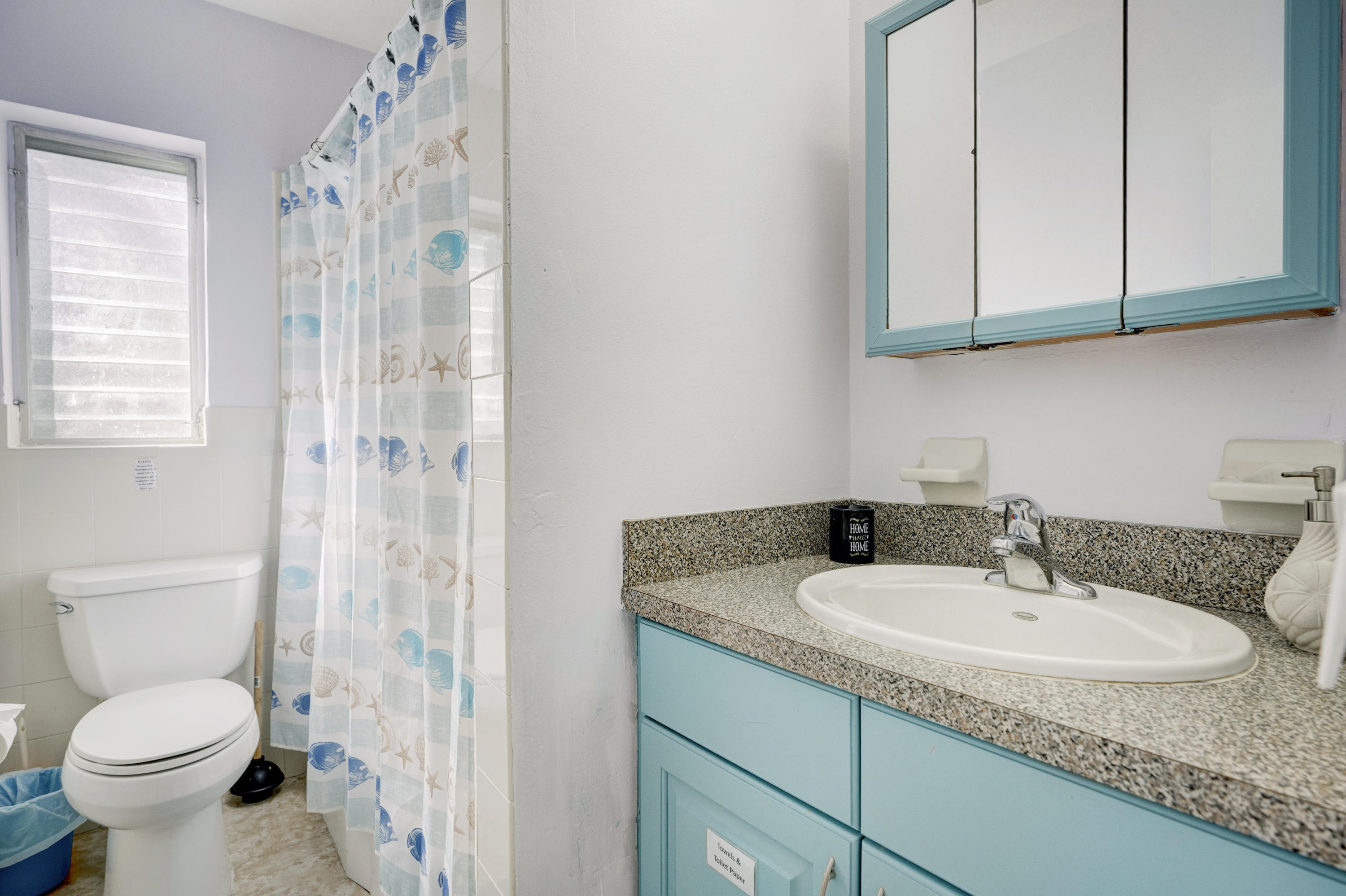 11061 Ellison Wilson Road North Palm Beach, FL 33408 - Photo 7 of 41 a bathroom with a granite countertop sink toilet and shower