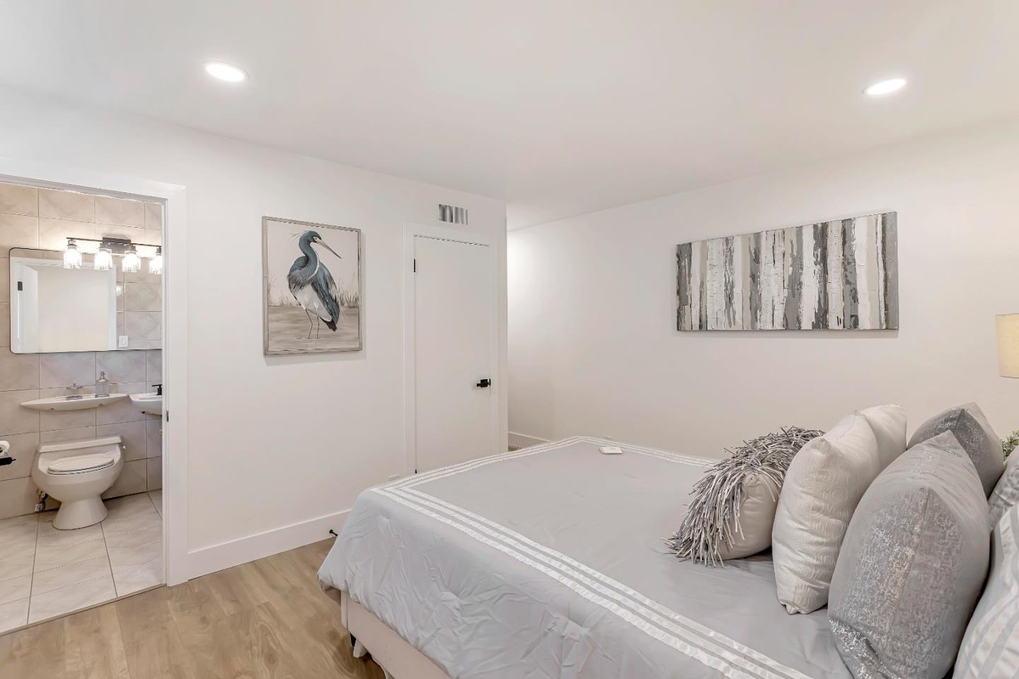 1548 Spring Street Mountain View, CA 94043 - Photo 20 of 40 a bedroom with a bed and a painting on the wall