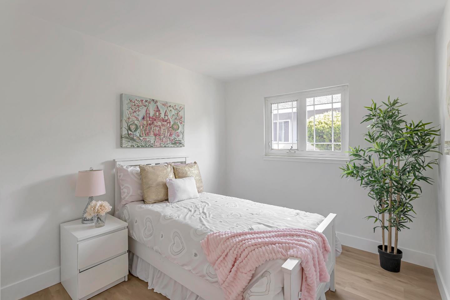 1548 Spring Street Mountain View, CA 94043 - Photo 23 of 40 a bedroom with a large bed and a potted plant