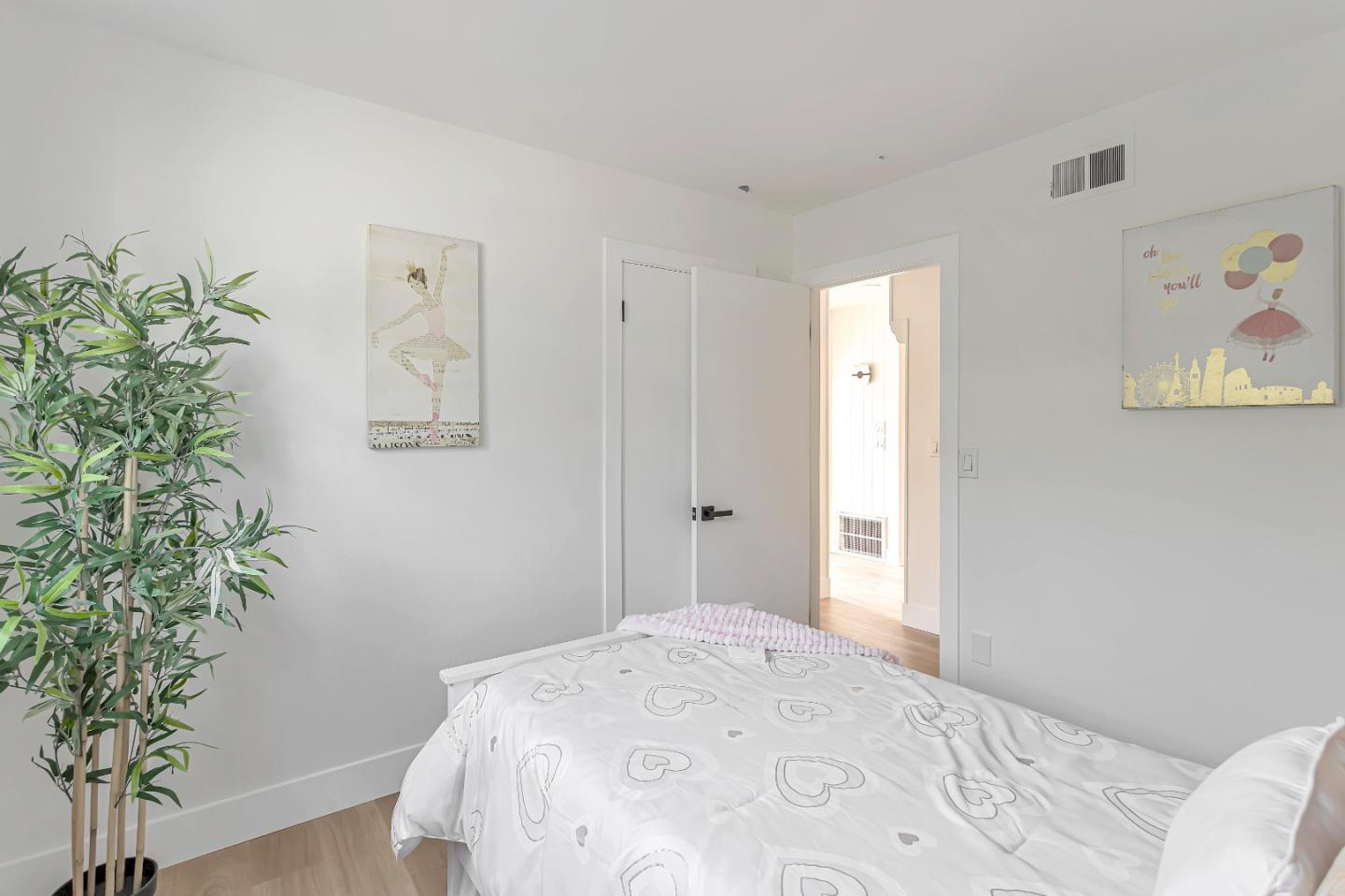 1548 Spring Street Mountain View, CA 94043 - Photo 24 of 40 a bedroom with a bed and a potted plant