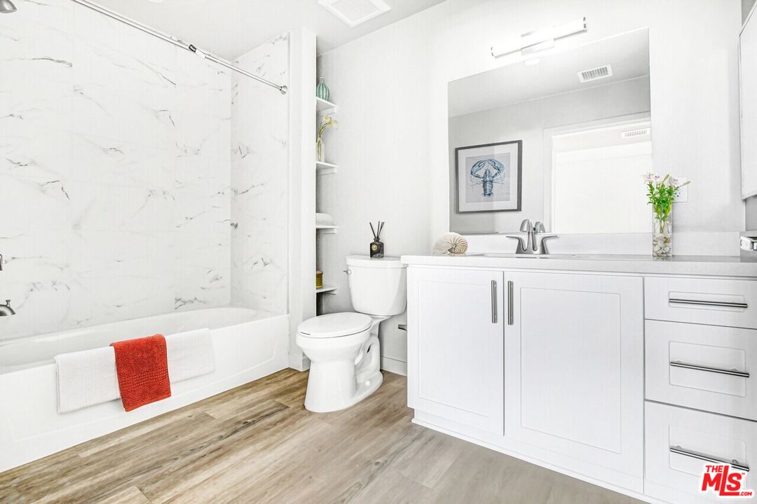2847 Leeward Avenue, Unit 607 Los Angeles, CA 90005 - Photo 5 of 14 a bathroom with a sink toilet and shower