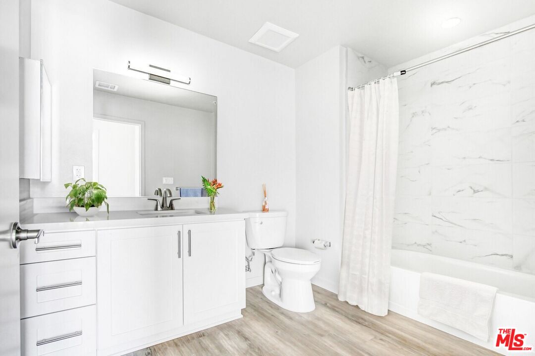2847 Leeward Avenue, Unit 607 Los Angeles, CA 90005 - Photo 8 of 14 a bathroom with a sink a toilet and a bathtub