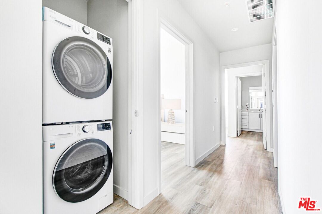 2847 Leeward Avenue, Unit 607 Los Angeles, CA 90005 - Photo 9 of 14 a view of a hallway with washer and dryer