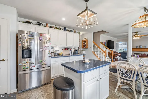 a kitchen with stainless steel appliances granite countertop a stove refrigerator and cabinets