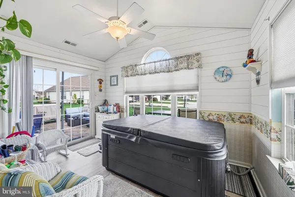 a living room with stainless steel appliances granite countertop furniture and a dining table