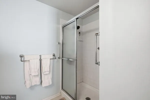 a bathroom with a glass shower door