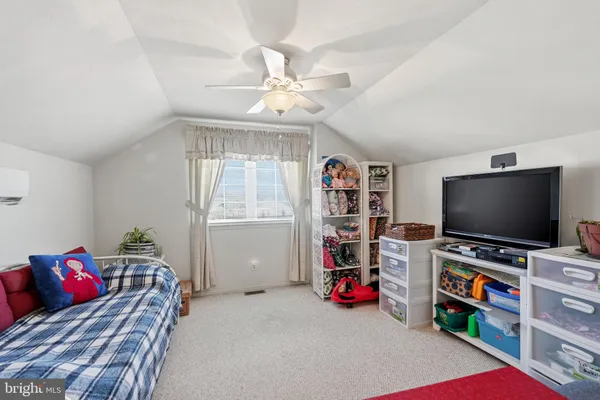 a living room with furniture and flat screen tv