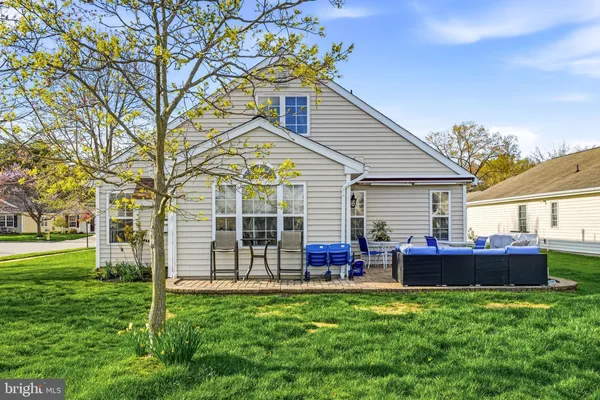 a front view of house with yard and outdoor seating