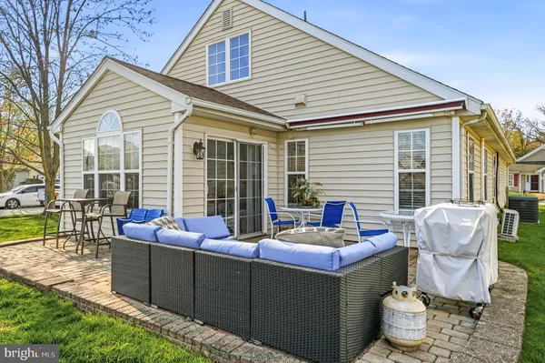 a swimming pool with outdoor seating and barbeque oven