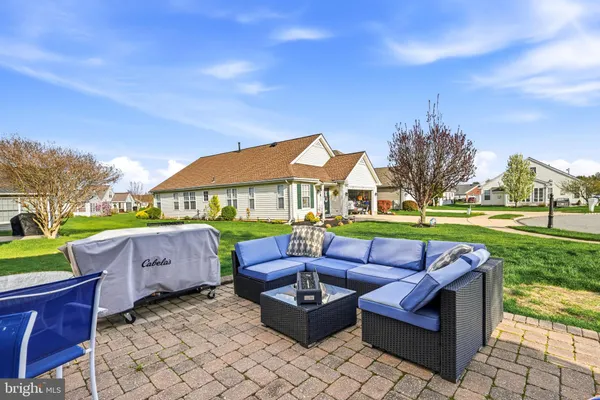 a view of a patio with couches table and chairs and potted plants