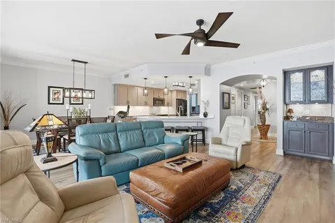 a living room with furniture a dining table and a fireplace