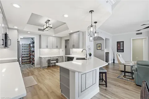 a kitchen with a sink cabinets and wooden floor