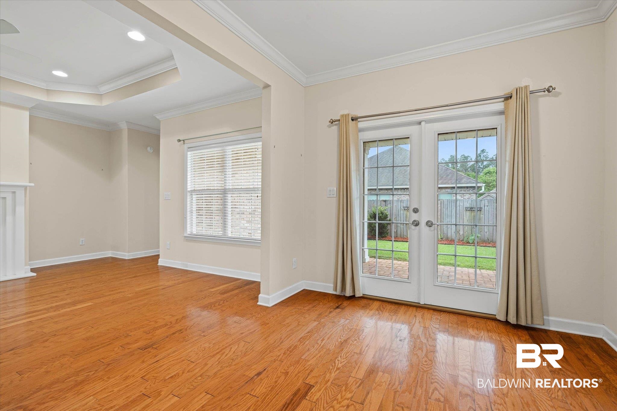 1003 Weatherby Street South Saraland, AL 36571 - Photo 14 of 31 Doorway featuring french doors, crown molding, wood finished floors, and a raised ceiling