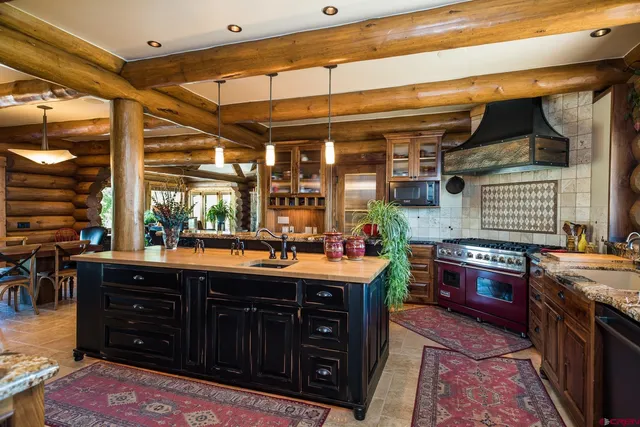 a view of a dinning room with granite countertop a table and chairs