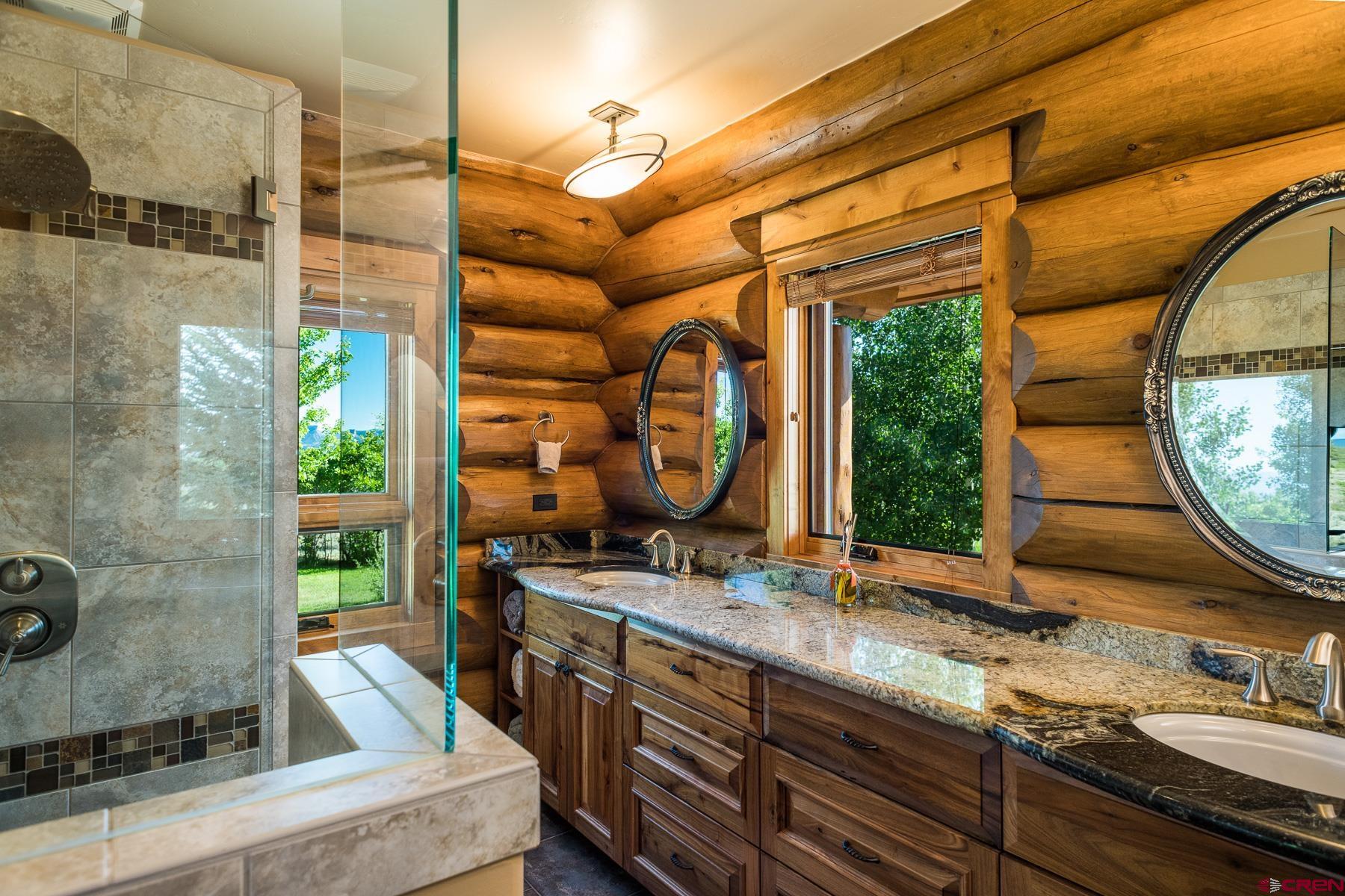 15255 Road 35 Mancos, CO 81328 - Photo 23 of 36 a bathroom with a granite countertop sink and a mirror